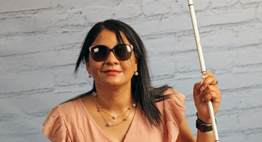 An NFB member poses for a photo with her cane.